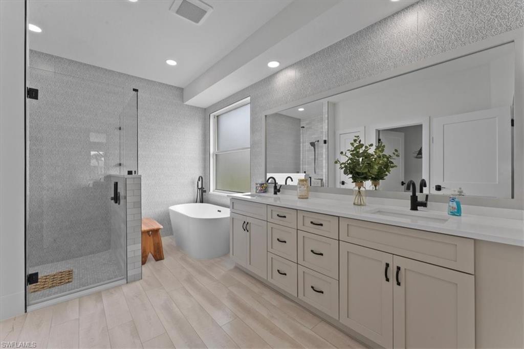 8541 Peppertree Way Naples, FL 34114 - Photo 24 of 41 a spacious bathroom with double sink a toilet a shower and a mirror