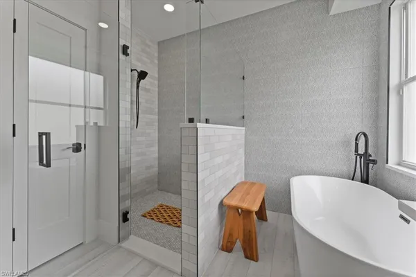a bathroom with a tub and shower