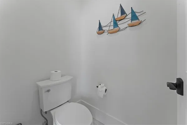 a white toilet sitting next to a bathroom sink