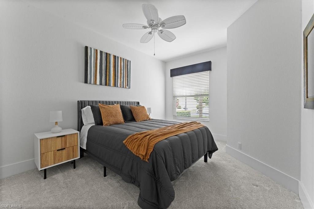 8541 Peppertree Way Naples, FL 34114 - Photo 27 of 41 a bed sitting in a bedroom next to a window