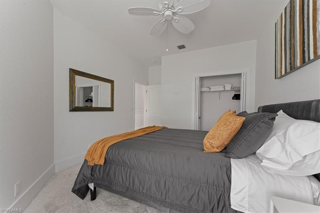 8541 Peppertree Way Naples, FL 34114 - Photo 28 of 41 a bedroom with a bed and a chandelier
