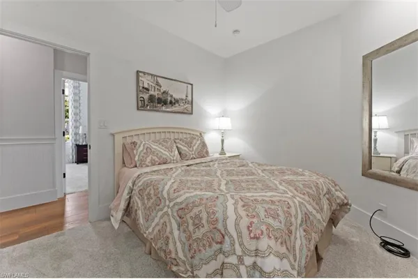 a bedroom with a bed and a lamp