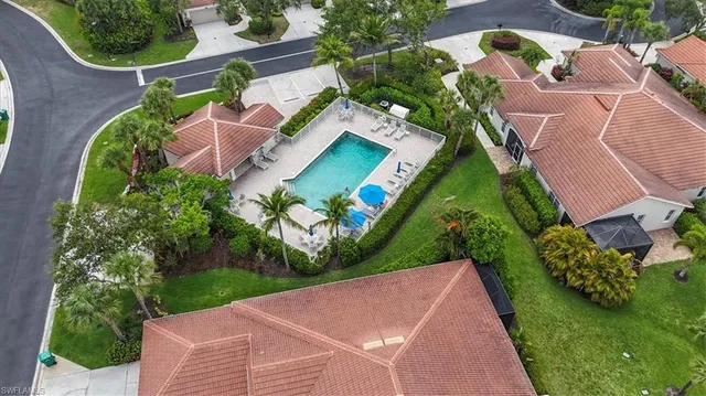an aerial view of residential houses with outdoor space and street view