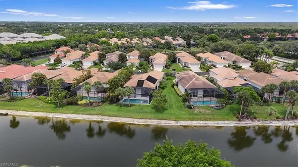 an aerial view of residential houses with outdoor space and river view