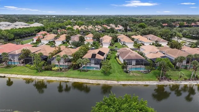 an aerial view of residential houses with outdoor space and river view