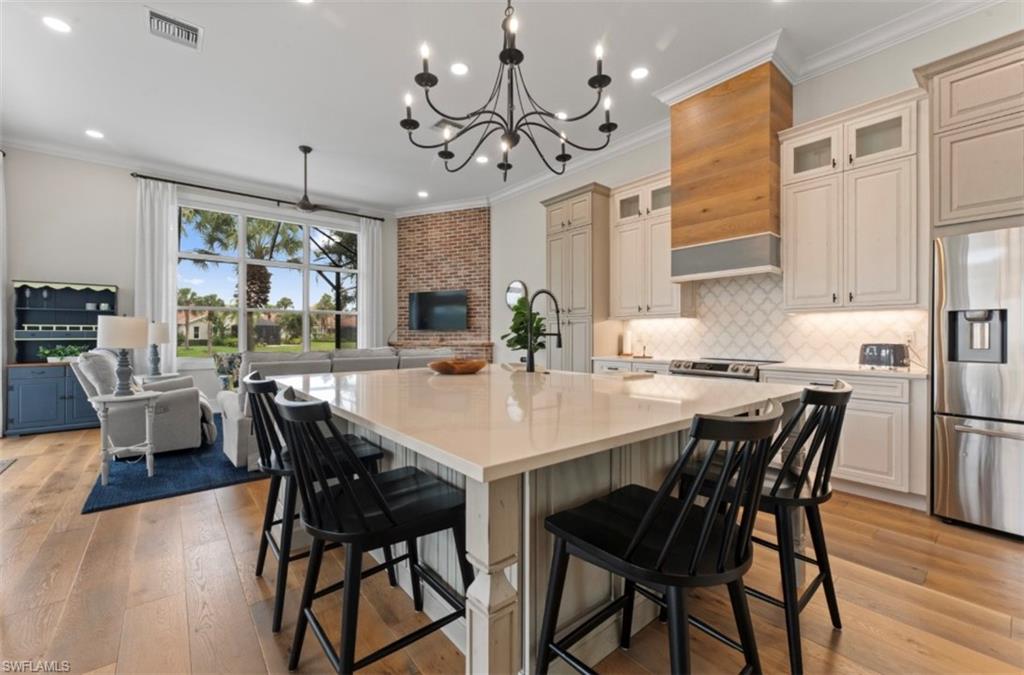 8541 Peppertree Way Naples, FL 34114 - Photo 7 of 41 a view of a dining room with furniture large window and wooden floor
