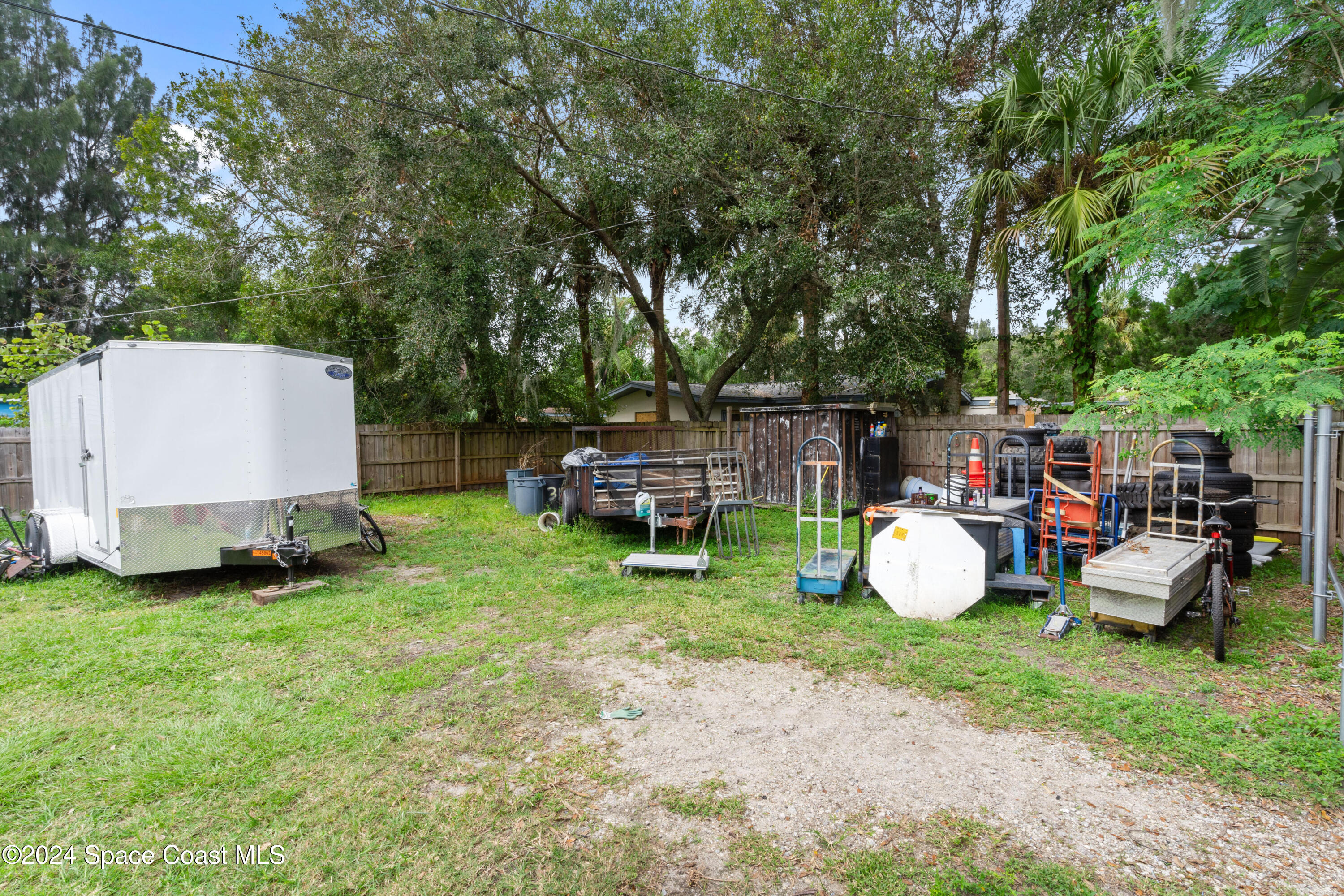 4260 Aurora Road Melbourne, FL 32934 - Photo 7 of 22 a view of a backyard with table and chairs and a fire pit