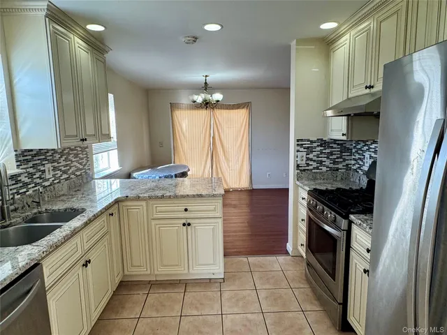 a kitchen with stainless steel appliances a stove sink and cabinets