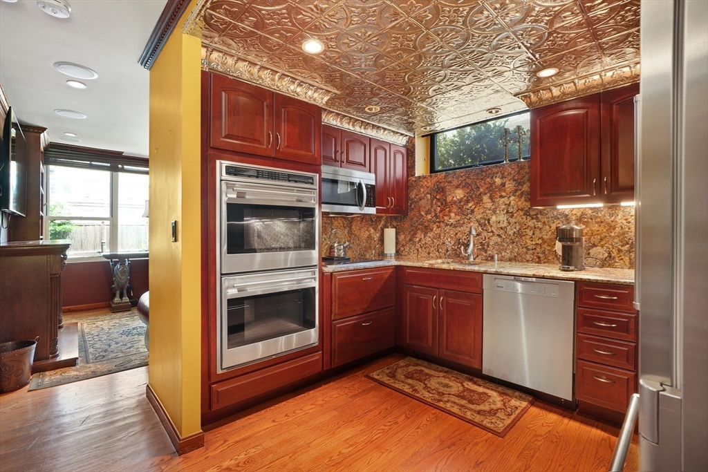 131 Perkins Street, Unit 131 Boston, MA 02130 - Photo 6 of 21 a kitchen with stainless steel appliances granite countertop a refrigerator and a stove