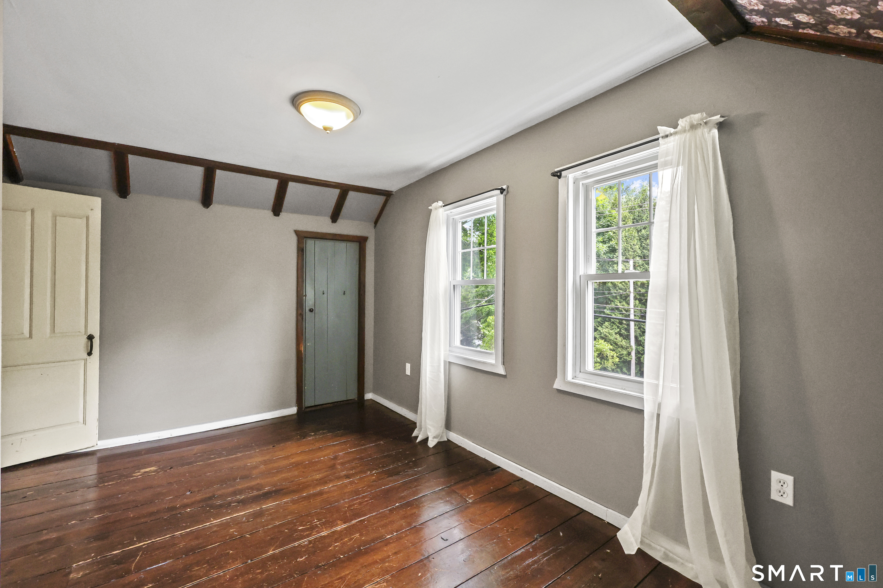 917 Hopewell Road Glastonbury, CT 06033 - Photo 21 of 39 an empty room with wooden floor and windows