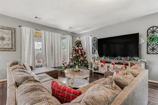 a living room with furniture and a flat screen tv