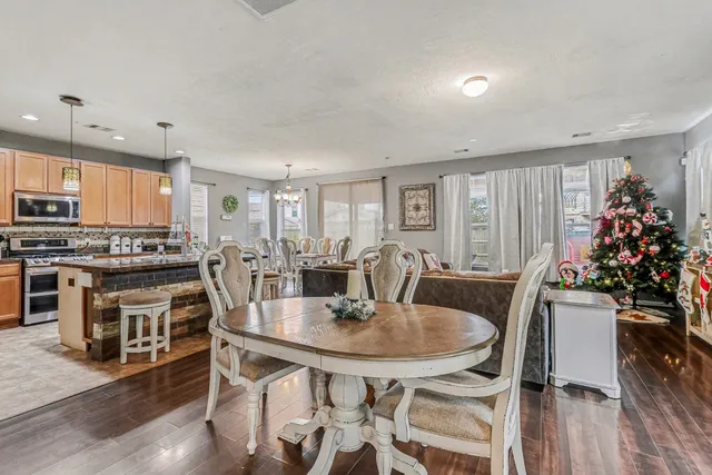 a view of a dining room with furniture and wooden floor
