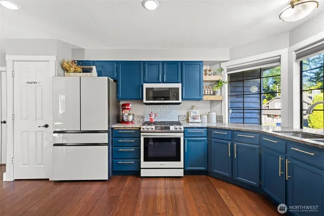 a view of a patio with couches table and chairs and potted plants