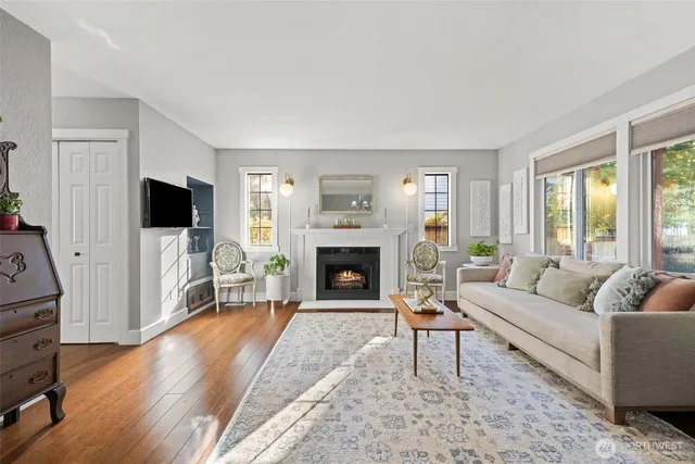 a living room with furniture a wooden floor and a rug