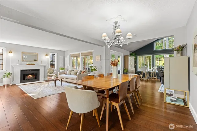a living room with furniture ceiling fan and a large window