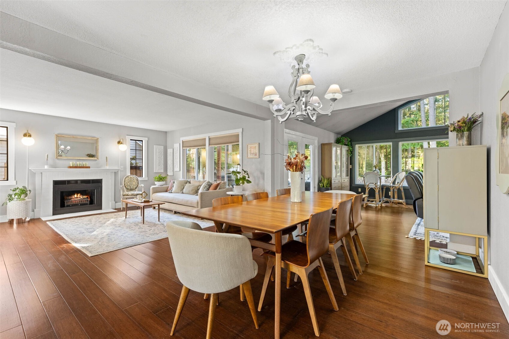 9630 50th Place West Mukilteo, WA 98275 - Photo 10 of 39 a dining room with wooden floor a chandelier a wooden table and chairs
