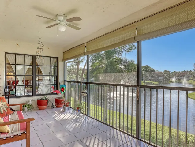 a front view of a house with a yard and fountain