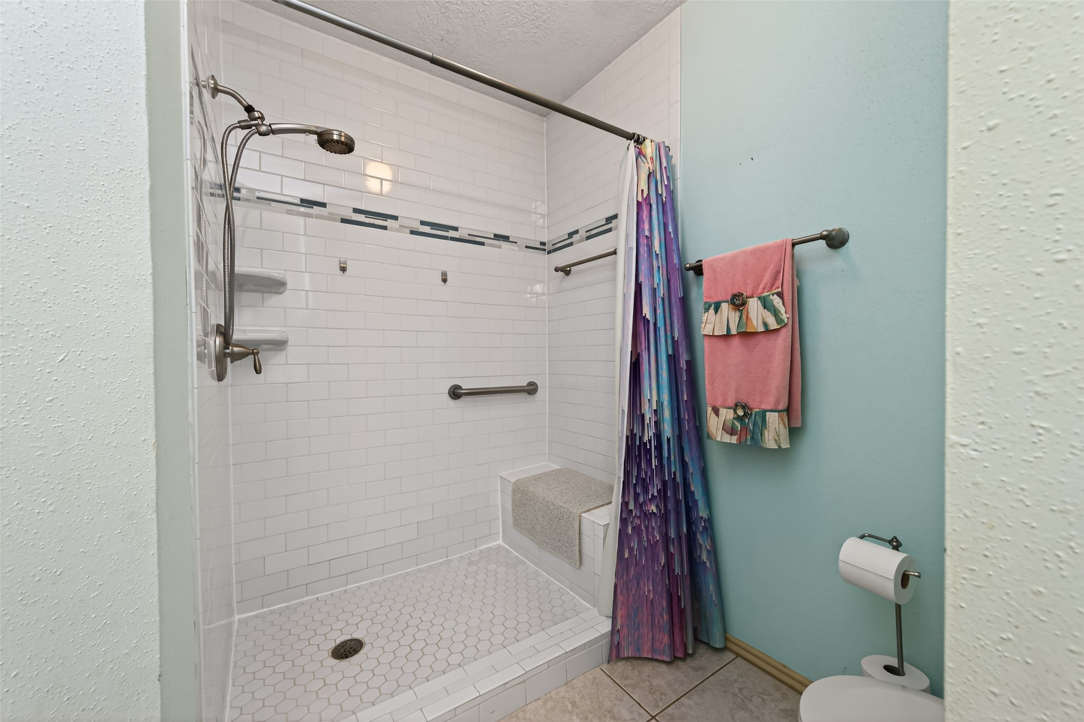 3639 Nutwood Lane Spring, TX 77389 - Photo 25 of 33 Accessible walk-in shower with built-in bench seating and handrail, offering everyday convenience.