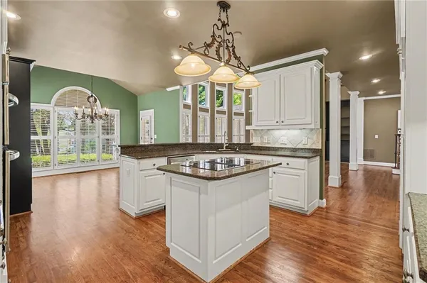 a kitchen with stainless steel appliances granite countertop a sink and cabinets