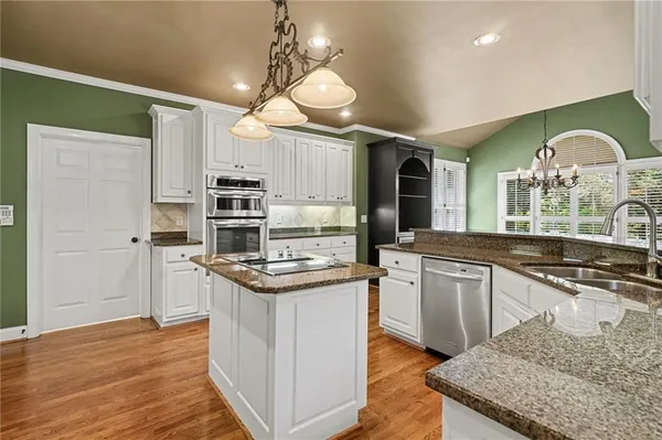 a view of a room with wooden floor and windows