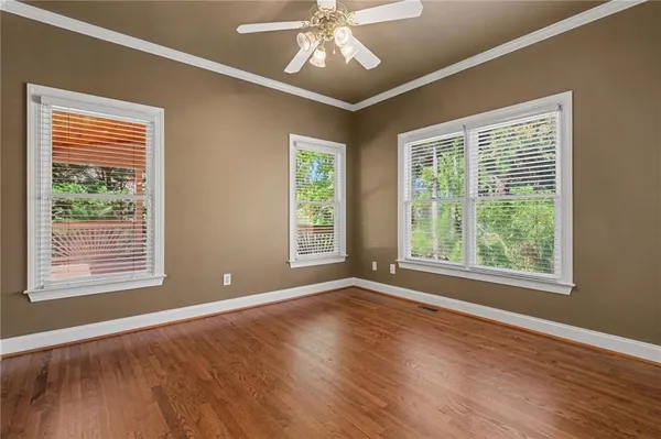 a bathroom with a bathtub shower sink mirror vanity and toilet