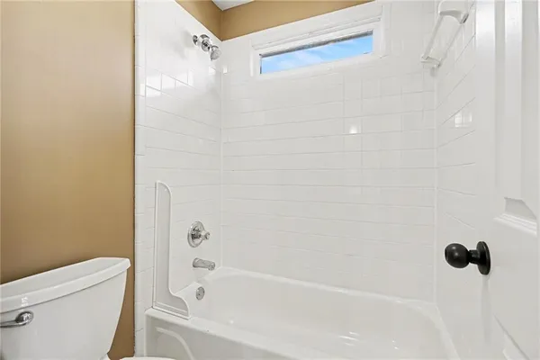 en empty room with windows and chandelier fan