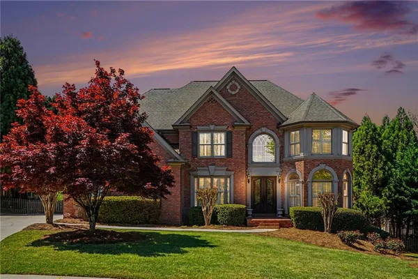 a front view of a house with a yard