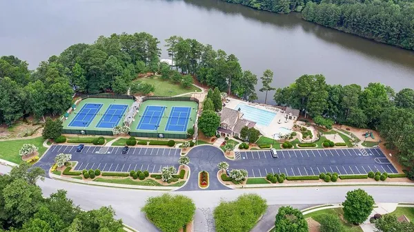an aerial view of a house with garden space and lake view