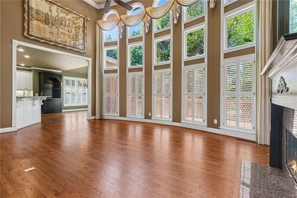 a view of an entryway with wooden floor and a fireplace