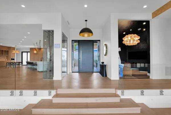 a view of kitchen with kitchen island stainless steel appliances refrigerator stove microwave and living room view