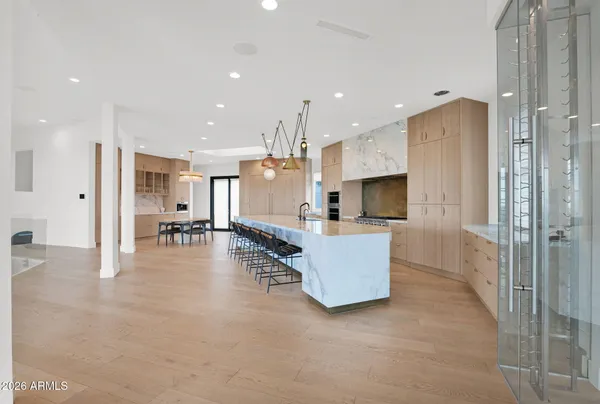 a kitchen with a table chairs stove and cabinets