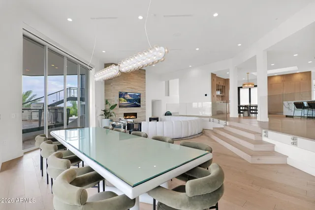 a living room with furniture and a chandelier