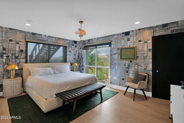 a bedroom with a bed and a chandelier