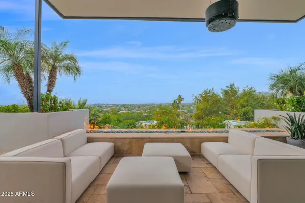 a view of a roof deck with couches table and chairs