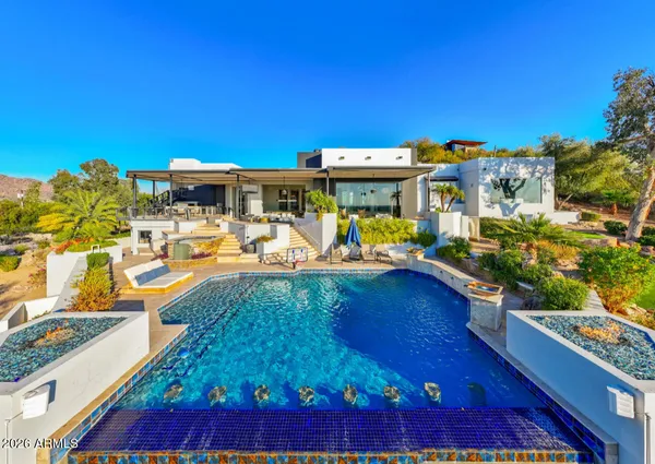 a view of a swimming pool with an outdoor seating
