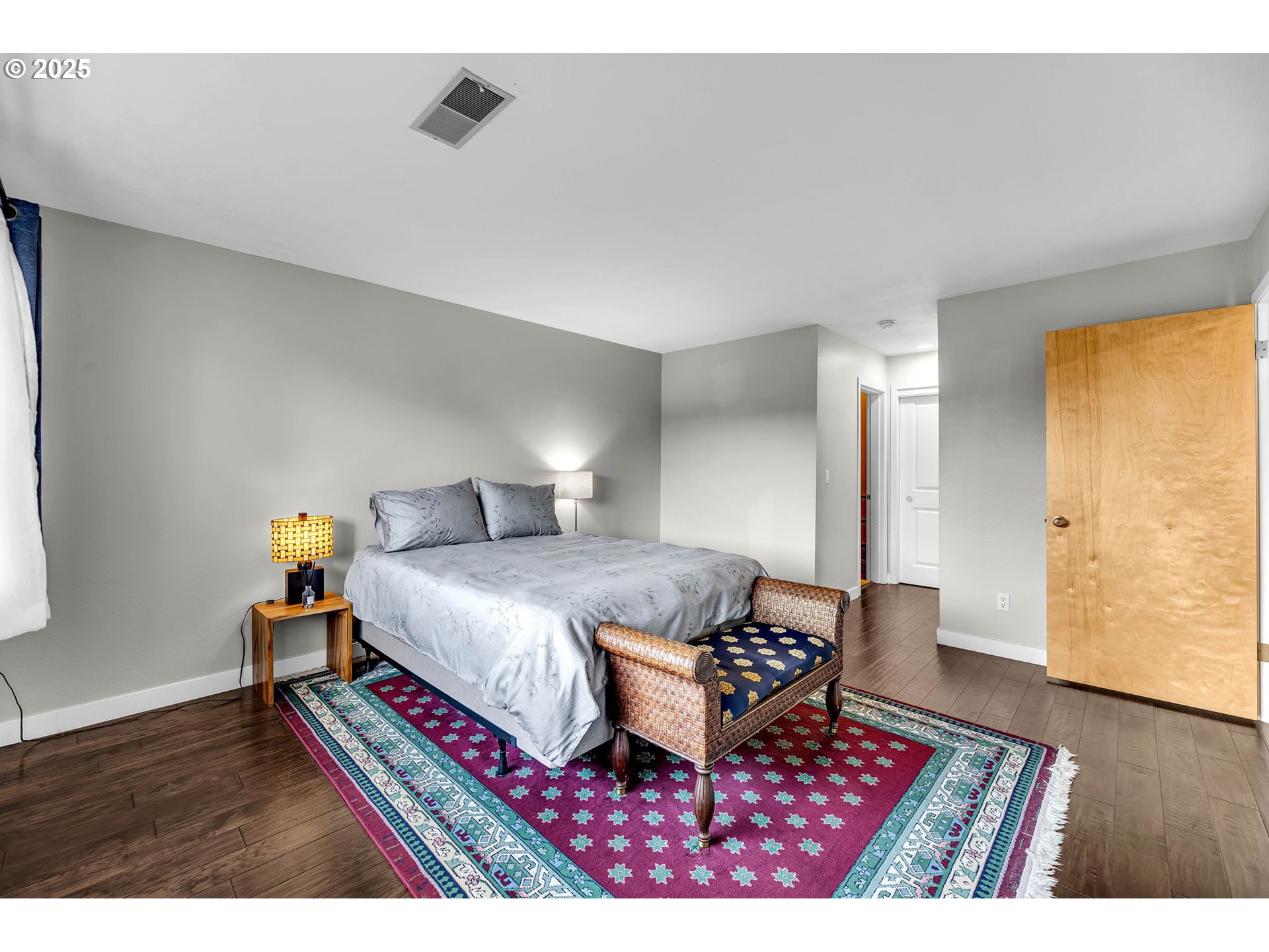 6902 Southeast Riverside Drive, Unit 6 Vancouver, WA 98664 - Photo 11 of 39 a bedroom with a bed and wooden floor