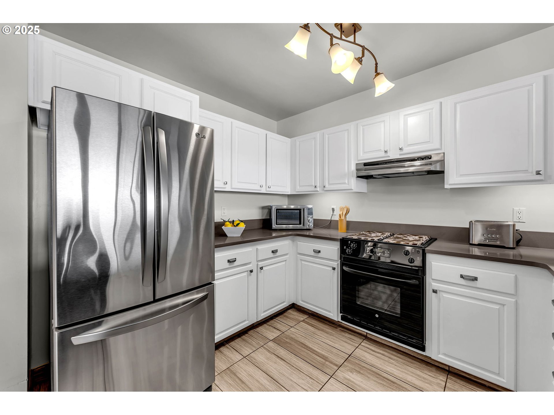 6902 Southeast Riverside Drive, Unit 6 Vancouver, WA 98664 - Photo 24 of 39 a kitchen with stainless steel appliances granite countertop a refrigerator sink and stove
