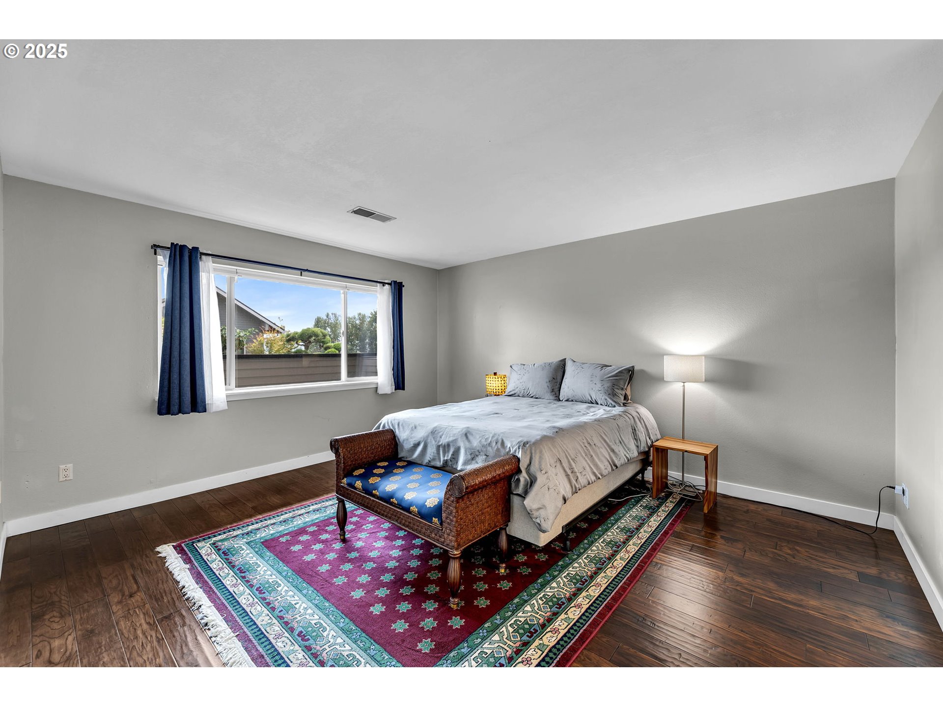 6902 Southeast Riverside Drive, Unit 6 Vancouver, WA 98664 - Photo 10 of 39 a bed room with a bed and a painting on the wall