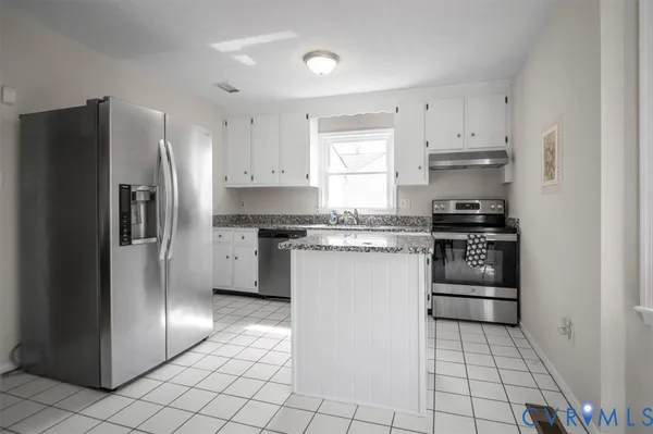 a kitchen with cabinets and stainless steel appliances