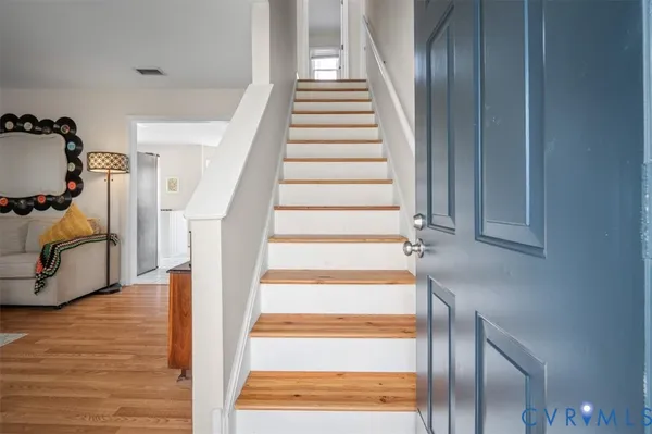 a view of staircase with white walls and windows