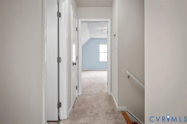 an empty room with windows and chandelier fan