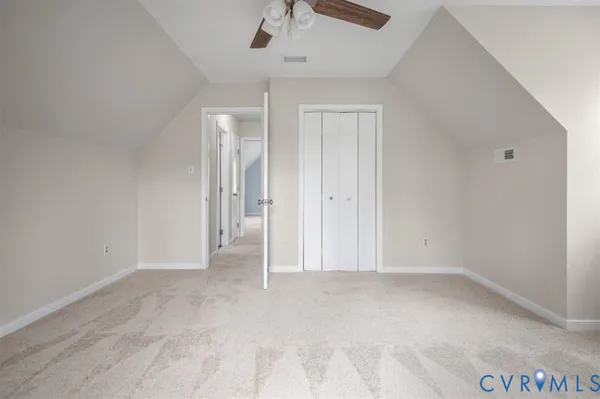 a view of a backyard with wooden fence and large trees
