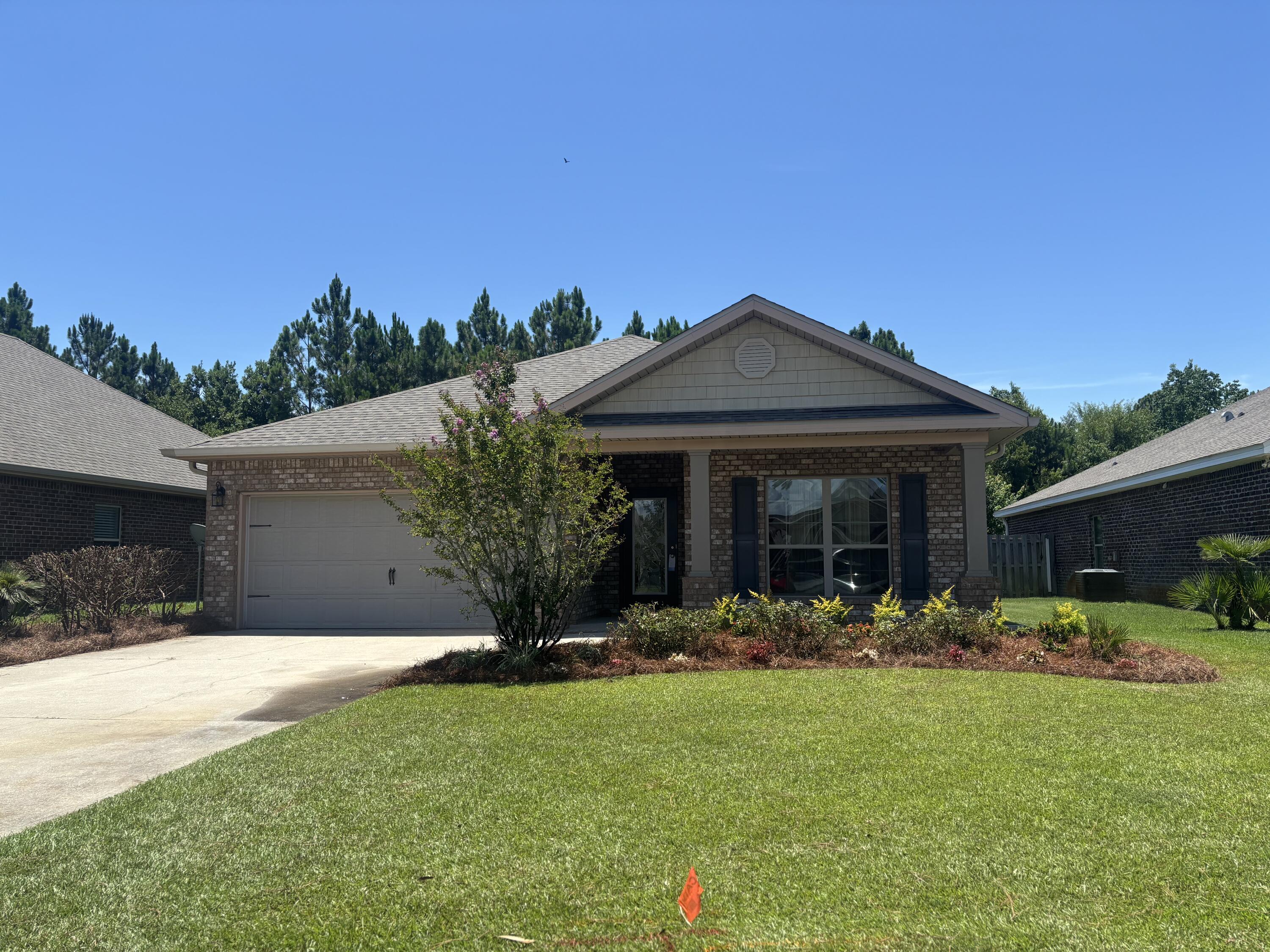 1058 Cocobolo Drive Santa Rosa Beach, FL 32459 - Photo 2 of 26 a front view of a house with a yard