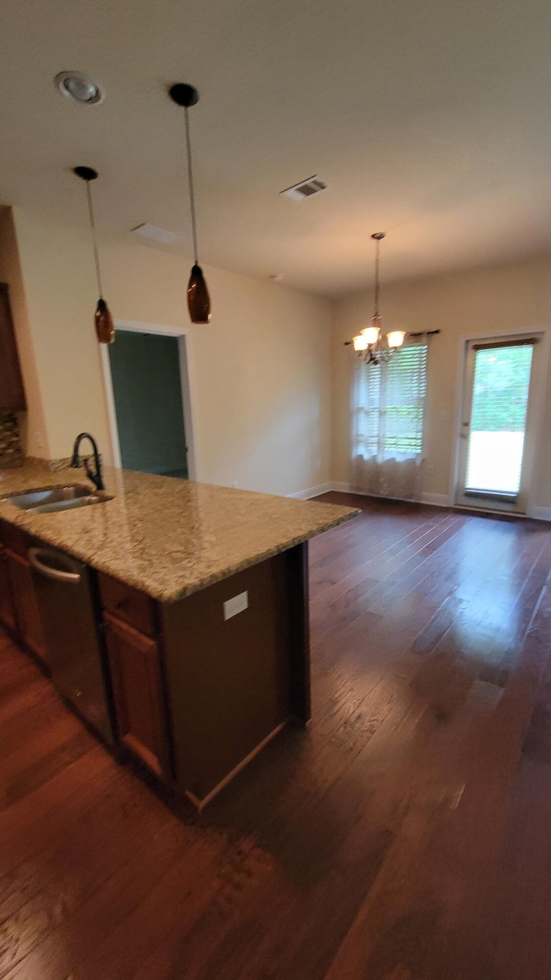 1058 Cocobolo Drive Santa Rosa Beach, FL 32459 - Photo 3 of 26 a kitchen with kitchen island a sink dishwasher and a stove with wooden floor