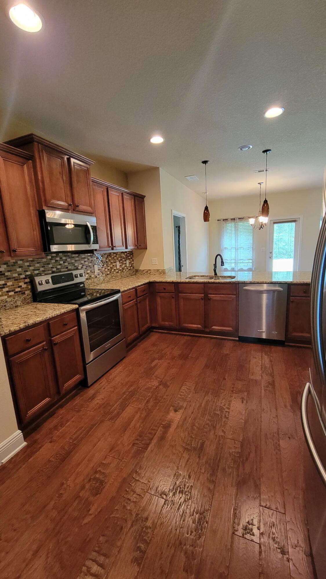 1058 Cocobolo Drive Santa Rosa Beach, FL 32459 - Photo 5 of 26 a large kitchen with stainless steel appliances granite countertop a stove and a sink