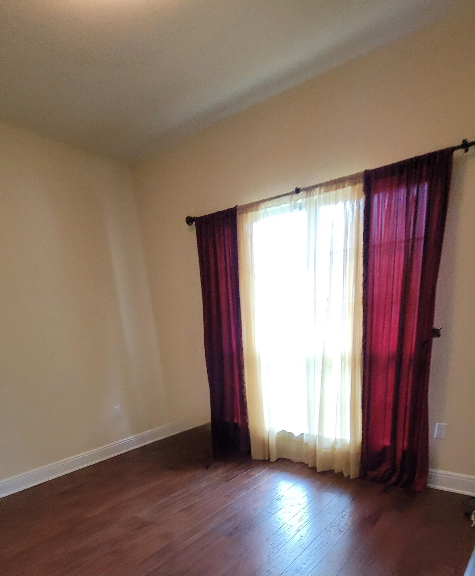 1058 Cocobolo Drive Santa Rosa Beach, FL 32459 - Photo 8 of 26 an empty room with wooden floor and windows