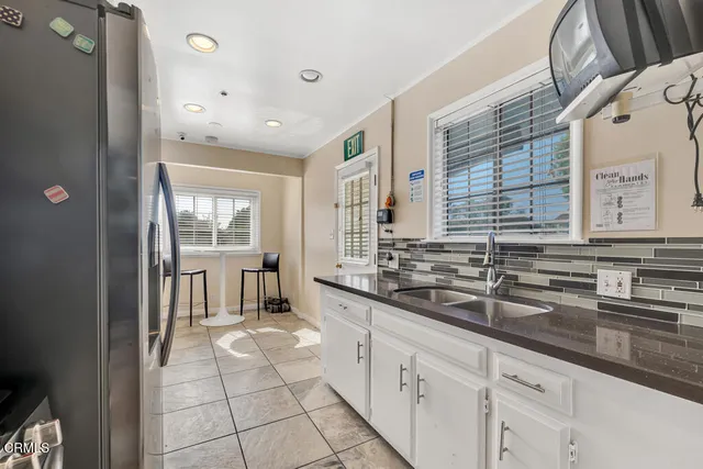 a large bathroom with a double vanity sink a mirror and a shower