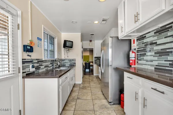 a kitchen with stainless steel appliances granite countertop a stove and a refrigerator