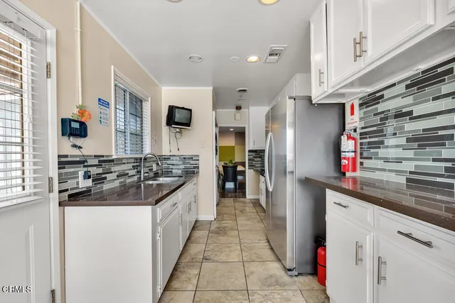 a kitchen with stainless steel appliances granite countertop a stove and a refrigerator