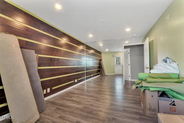 a view of room with wooden floor and stairs